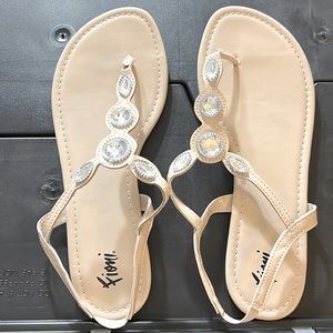 Bejeweled Patent leather like TStrap sandals.